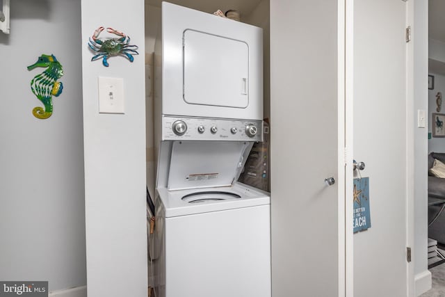 laundry area with stacked washing maching and dryer