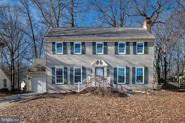 colonial inspired home featuring a garage