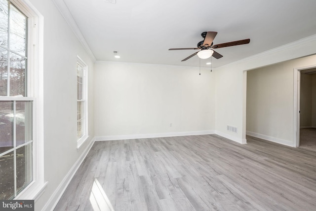 empty room with ornamental molding, ceiling fan, and light hardwood / wood-style flooring