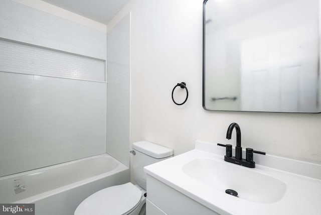 full bathroom featuring tiled shower / bath, vanity, and toilet