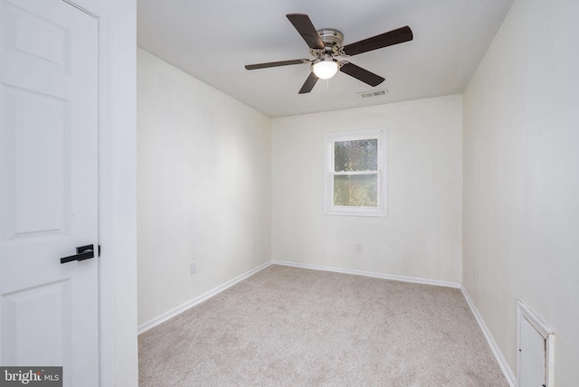 empty room with ceiling fan and light carpet