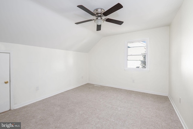 additional living space featuring lofted ceiling, light colored carpet, and ceiling fan