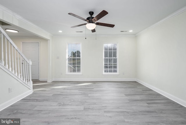 empty room featuring ornamental molding, light hardwood / wood-style floors, and ceiling fan