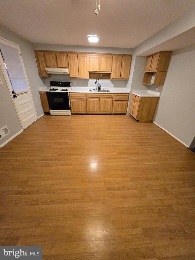 kitchen featuring sink, range with gas cooktop, and light hardwood / wood-style floors