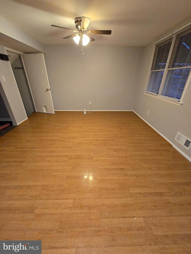 unfurnished room featuring ceiling fan and light wood-type flooring