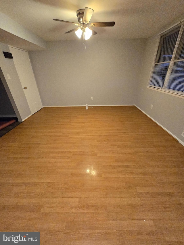 empty room with light hardwood / wood-style flooring and ceiling fan