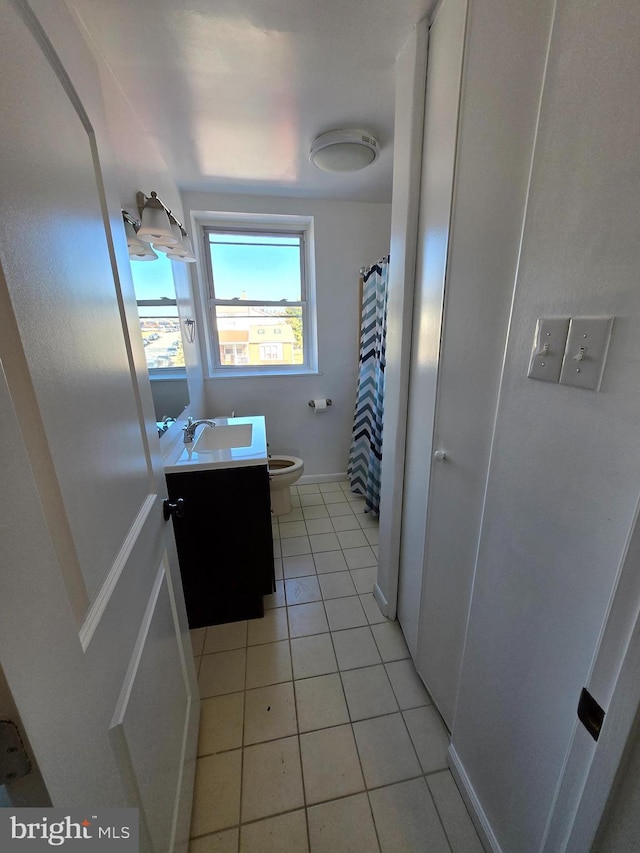 bathroom with a shower with curtain, vanity, tile patterned floors, and toilet