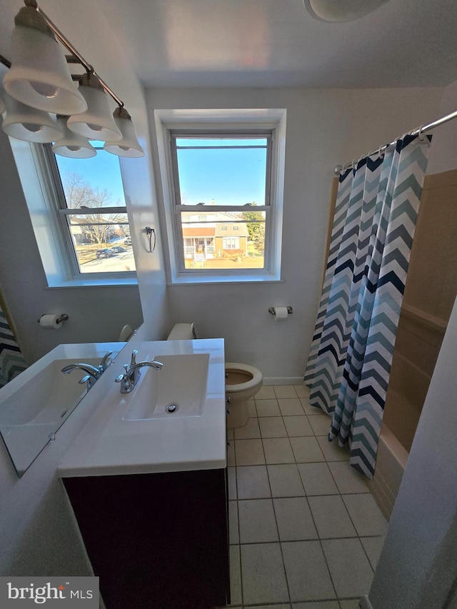 full bathroom featuring vanity, tile patterned floors, toilet, and shower / bath combo with shower curtain