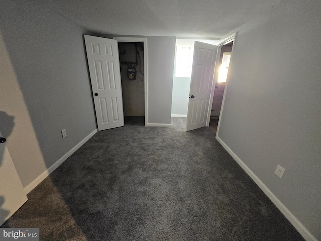 unfurnished bedroom featuring dark colored carpet