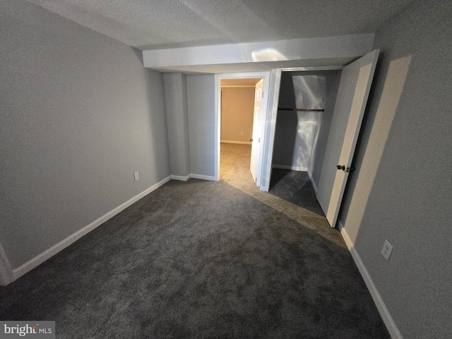 empty room featuring carpet and a textured ceiling