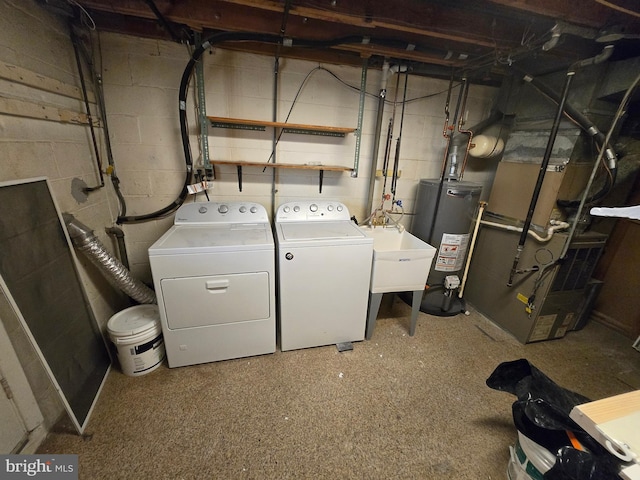 laundry area featuring gas water heater and washing machine and clothes dryer