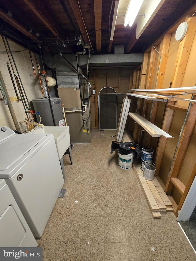 basement featuring water heater and washer and clothes dryer