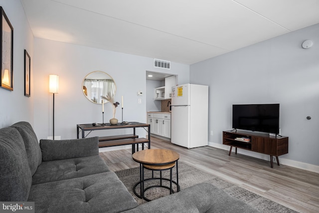 living room with light hardwood / wood-style floors