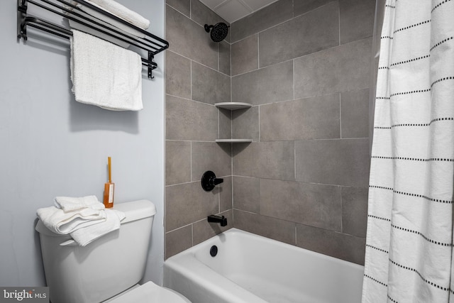 bathroom featuring shower / bath combo and toilet