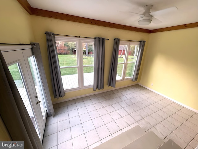 unfurnished room featuring light tile patterned floors, beamed ceiling, and ceiling fan