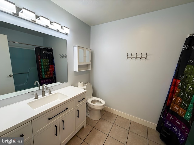 bathroom with tile patterned flooring, vanity, and toilet