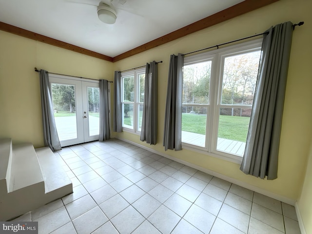 doorway with beamed ceiling, light tile patterned floors, and french doors