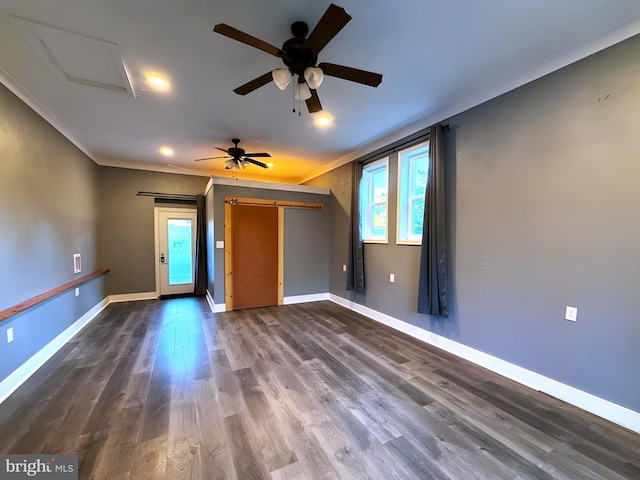 interior space with crown molding, a barn door, and hardwood / wood-style flooring