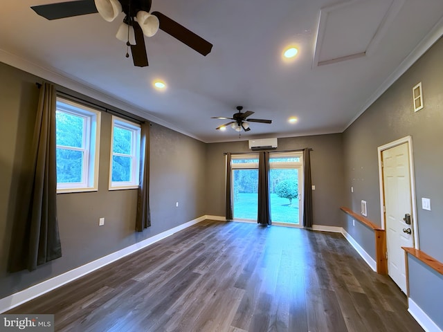 unfurnished room featuring dark hardwood / wood-style flooring, crown molding, and a wall unit AC