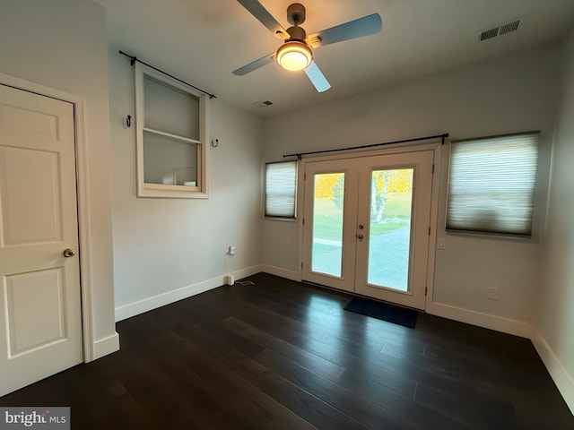 unfurnished room featuring ceiling fan, dark hardwood / wood-style flooring, and french doors