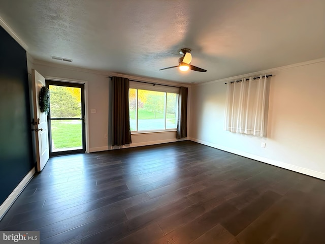 empty room featuring ornamental molding, dark hardwood / wood-style floors, ceiling fan, and a textured ceiling