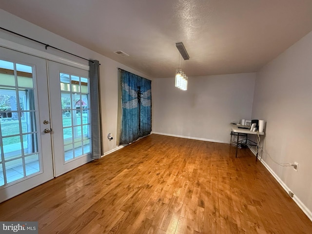 interior space with hardwood / wood-style flooring and french doors