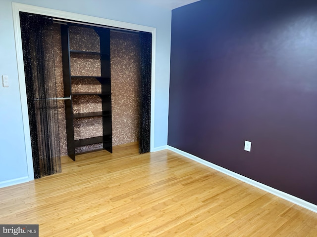 unfurnished room featuring hardwood / wood-style flooring