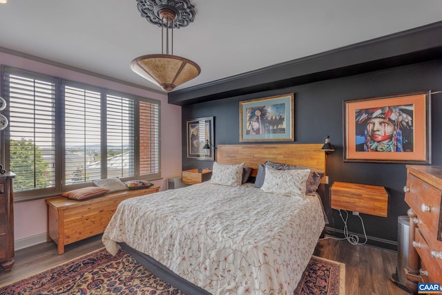 bedroom with dark hardwood / wood-style floors