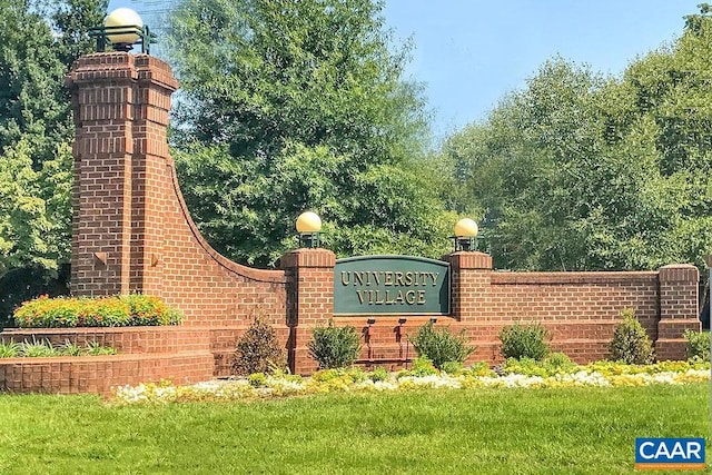 community / neighborhood sign with a lawn