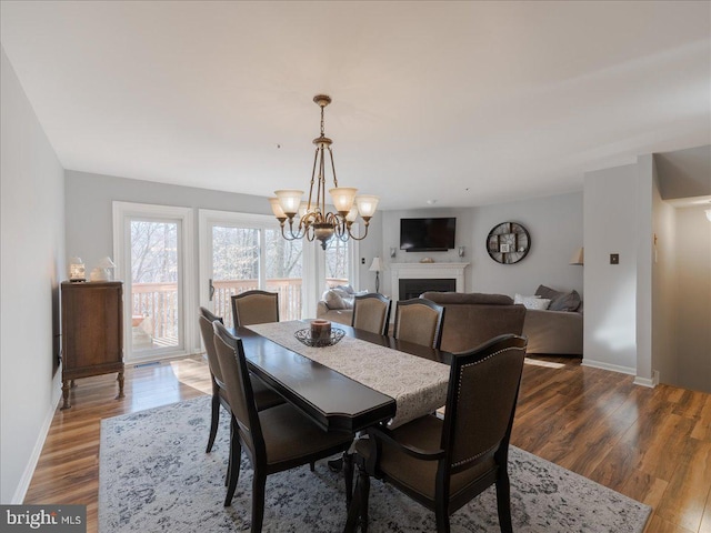 dining space featuring a notable chandelier and wood-type flooring