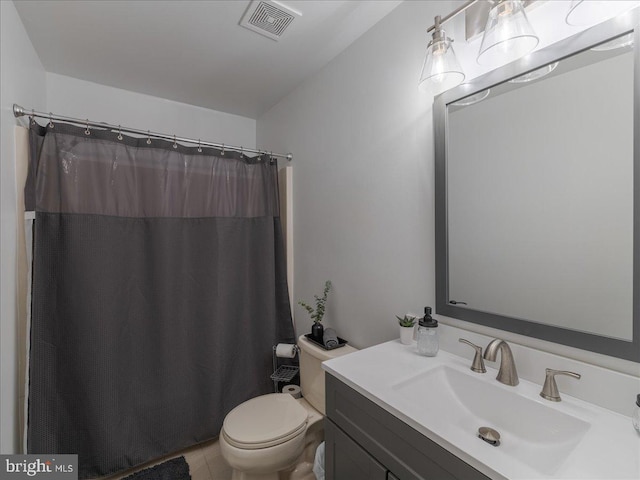 bathroom featuring vanity, toilet, and curtained shower