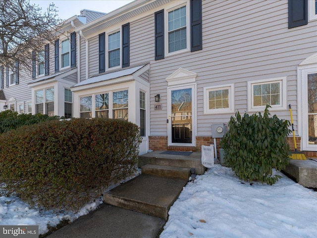 view of snow covered property entrance