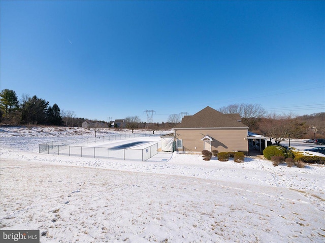 view of snow covered rear of property