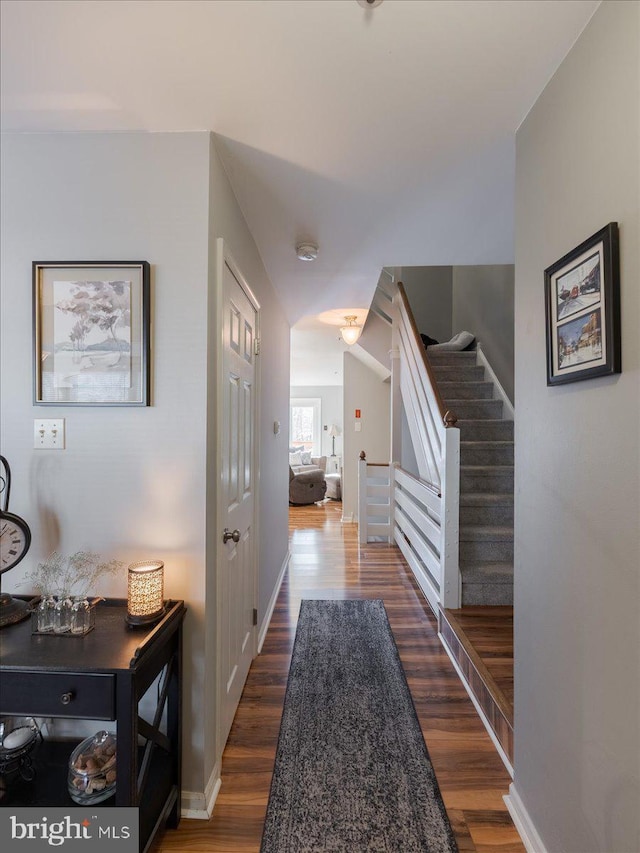 hallway with dark hardwood / wood-style floors