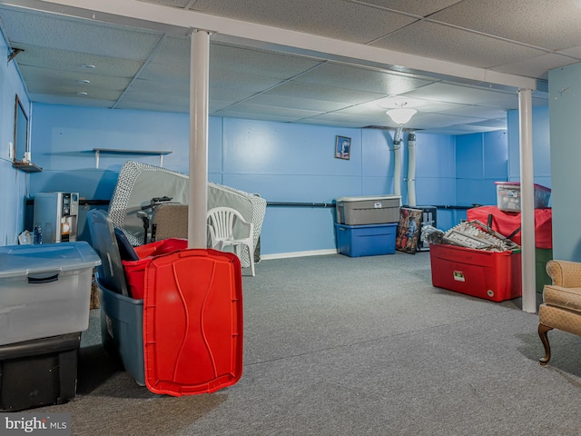 basement with carpet floors and a drop ceiling