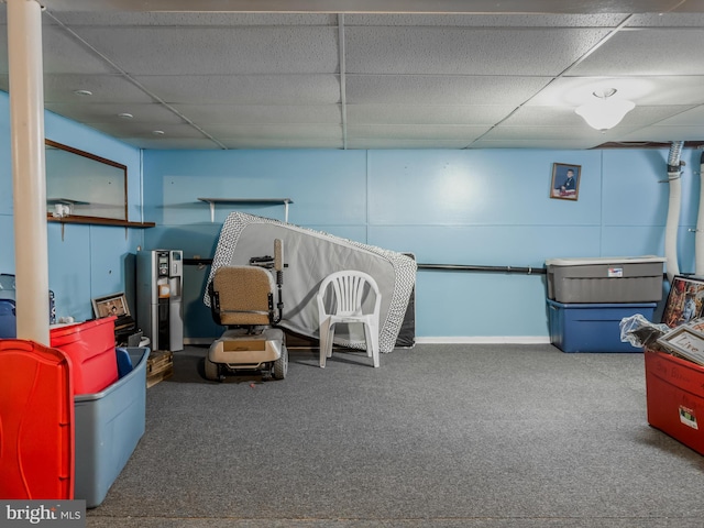 interior space with carpet floors and a drop ceiling