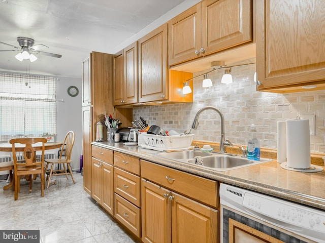 kitchen featuring tasteful backsplash, sink, and ceiling fan