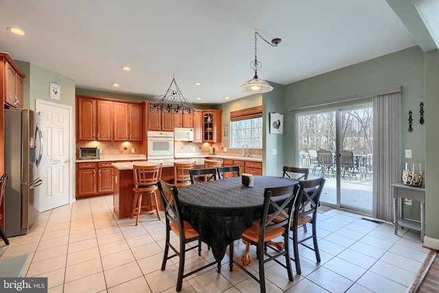 tiled dining space featuring sink