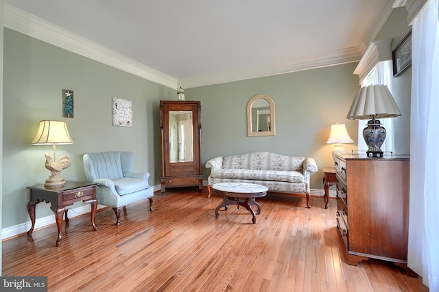 sitting room with crown molding and light wood-type flooring