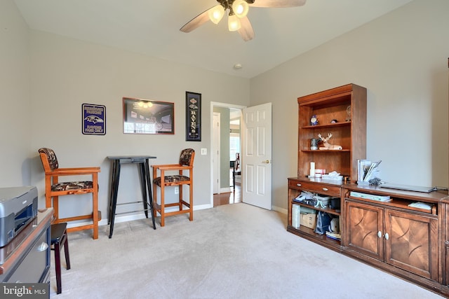 interior space featuring light carpet and ceiling fan