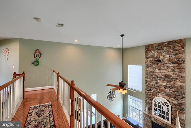 hall with hardwood / wood-style flooring and a high ceiling