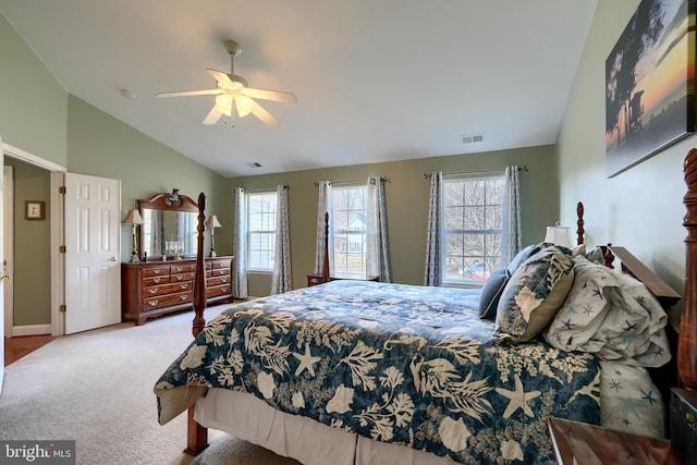 bedroom with ceiling fan, light colored carpet, and vaulted ceiling