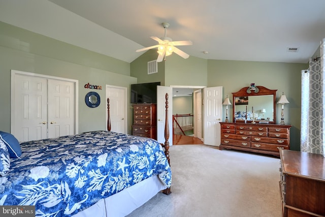 carpeted bedroom featuring lofted ceiling, ceiling fan, and multiple closets