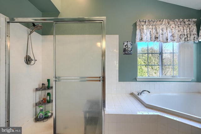 bathroom featuring shower with separate bathtub