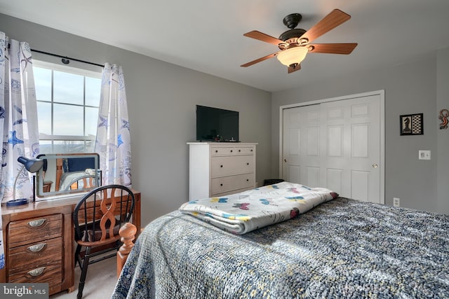 bedroom with carpet, ceiling fan, and a closet