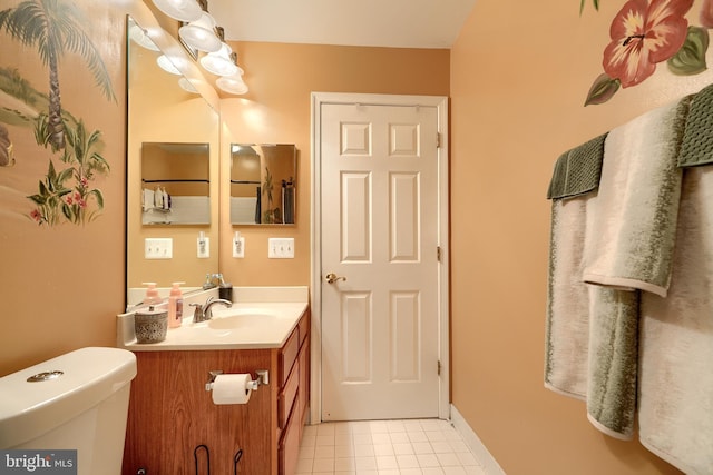 bathroom featuring tile patterned flooring, vanity, and toilet