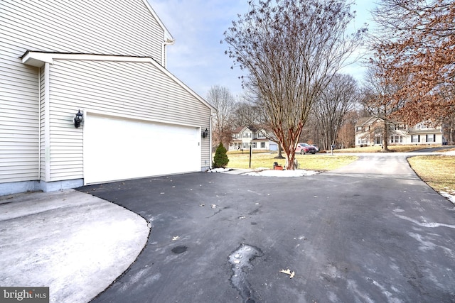 view of side of home featuring a garage