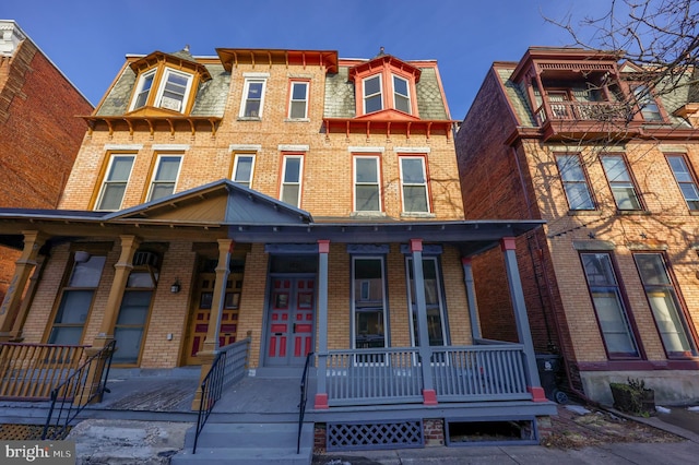 townhome / multi-family property featuring a porch