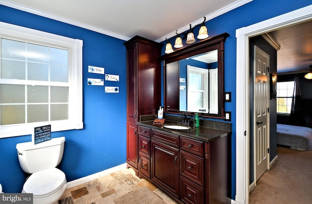 bathroom with crown molding, vanity, and toilet