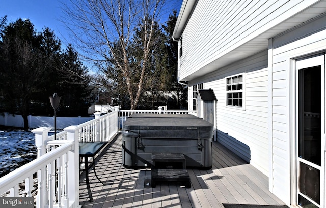 snow covered deck with a hot tub